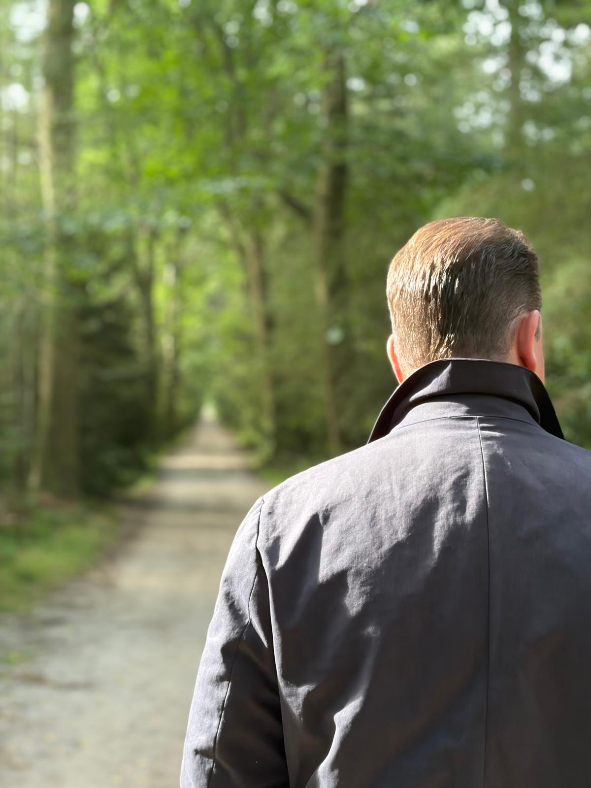 Patrick van der Meulen walking along a forest path